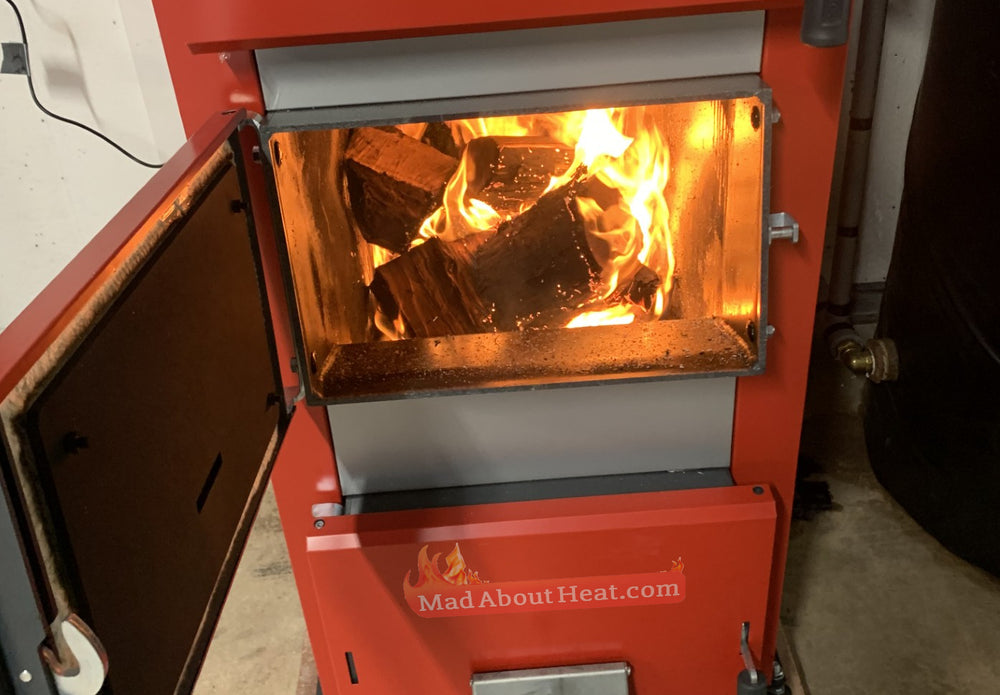 Log boiler, biomass central heating, 30kW and 1000 litre buffer tank.